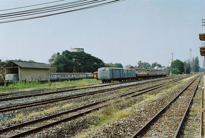 Train on railroad tracks against clear sky