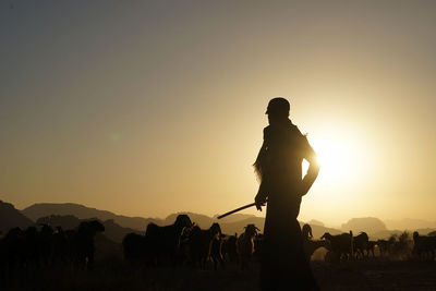 Silhouette people standing on mountain against clear sky