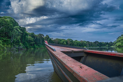 Boat moored in lake against sky