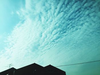 Low angle view of building against cloudy sky