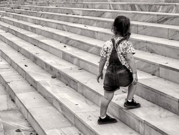 Rear view of woman walking on steps