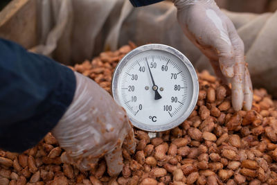 High angle view of hand holding clock