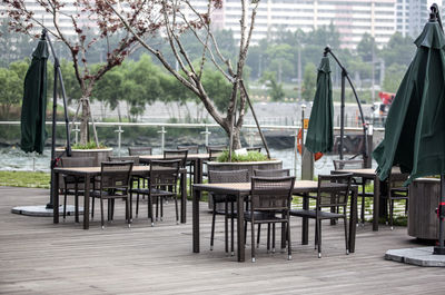 Empty chairs and tables arranged at outdoor cafe