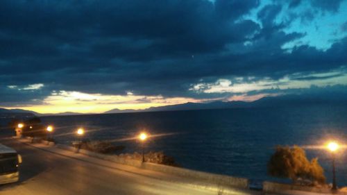 View of road against cloudy sky at dusk