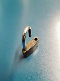 Close-up of padlock on blue background