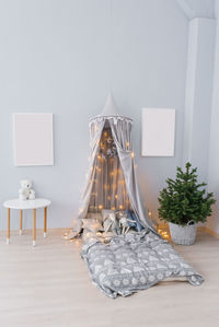 The interior of the children's room, decorated for christmas. awning with lights and pillows