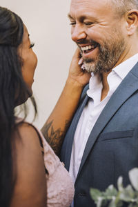 Happy newlywed multiracial couple looking at each other