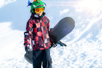 Portrait of boy with snowboard