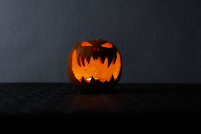 Close-up of illuminated pumpkin on table