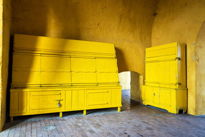 Yellow cabinets in clock tower by wall