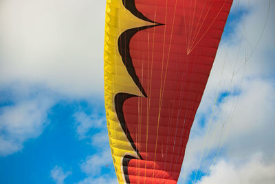 Low angle view of paragliding canopy against sky