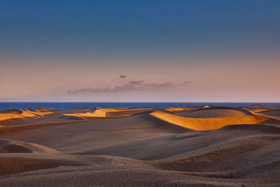 Scenic view of beach against sky during sunset