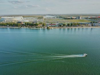 High angle view of city by sea against sky