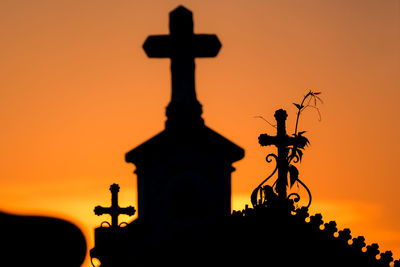 Silhouette of statue against sky at sunset