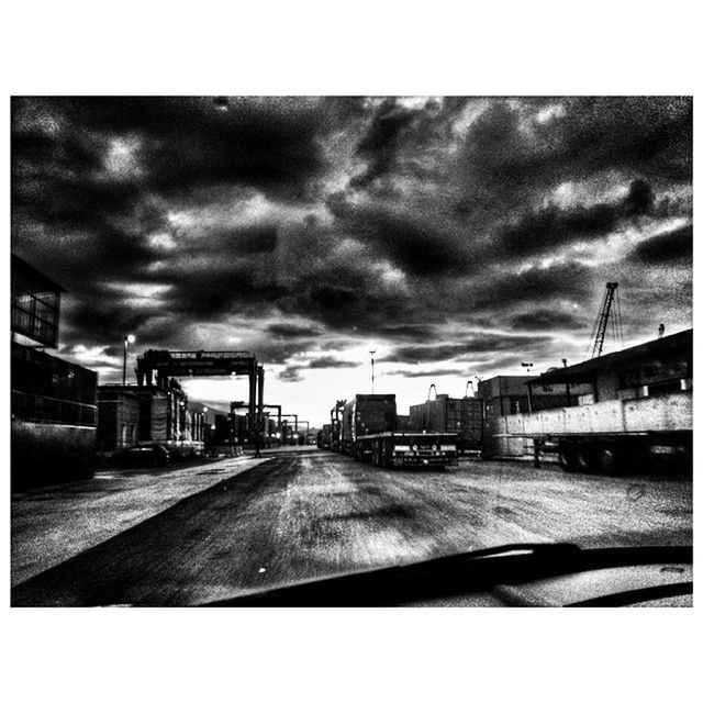 transfer print, building exterior, sky, architecture, built structure, cloud - sky, auto post production filter, cloudy, city, the way forward, cloud, road, transportation, diminishing perspective, overcast, street, weather, dusk, storm cloud, street light