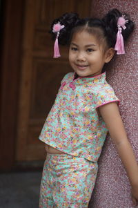 Portrait of a smiling girl standing outdoors