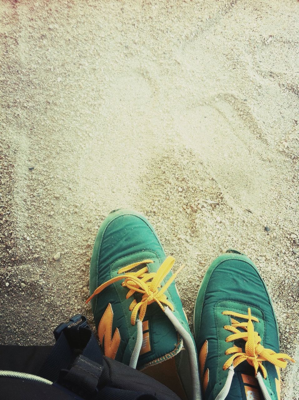 low section, person, shoe, personal perspective, high angle view, footwear, sand, beach, human foot, day, outdoors, standing, pattern, lifestyles, leisure activity, street, sunlight