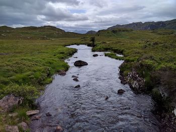 Scenic view of waterfall against sky