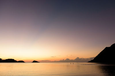 Scenic view of sea against clear sky during sunset