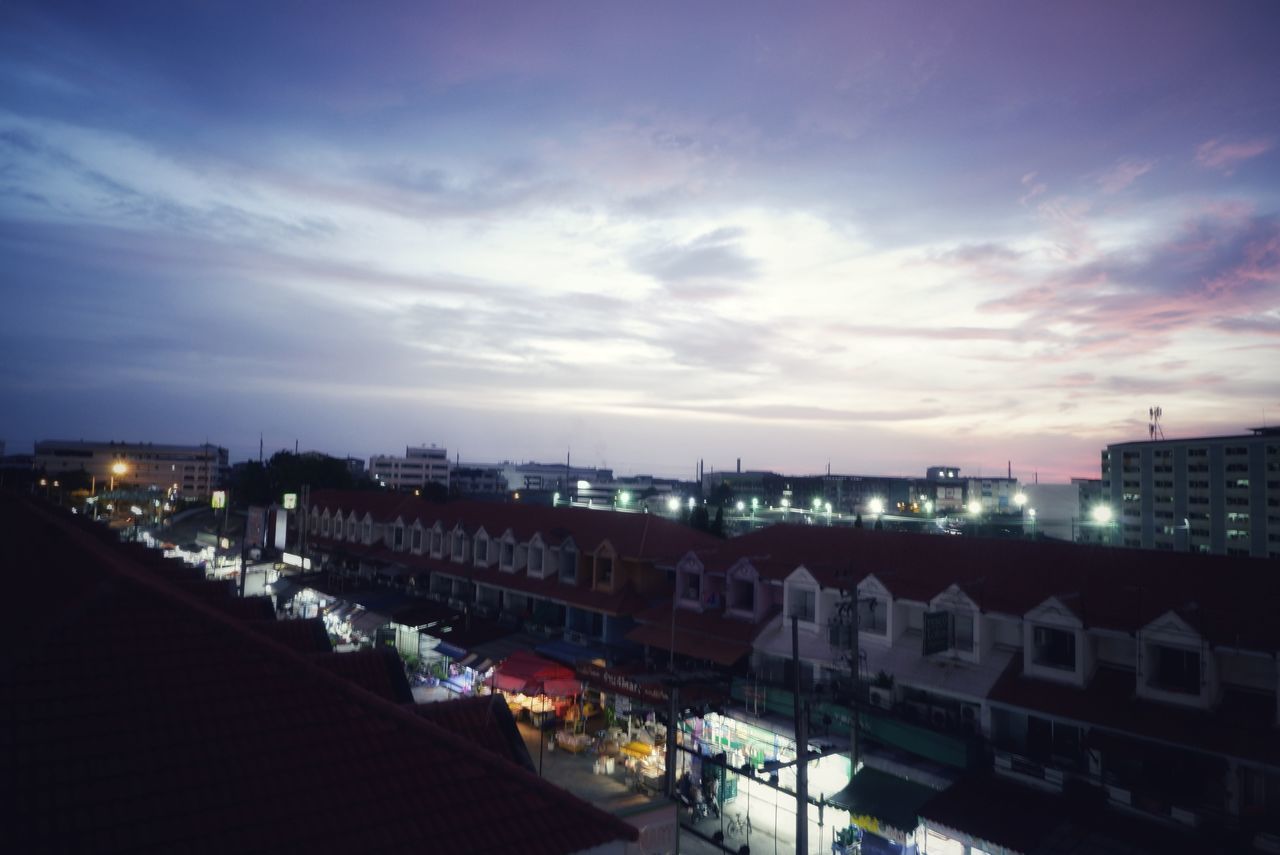 HIGH ANGLE VIEW OF ILLUMINATED BUILDINGS AT NIGHT