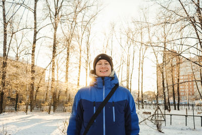 Portrait of teenage girl standing in snow