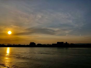 Scenic view of lake against sky during sunset