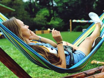 Woman lying down on hammock