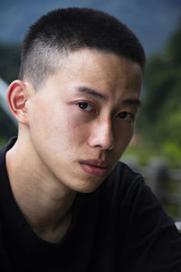 Close-up portrait of young man looking away