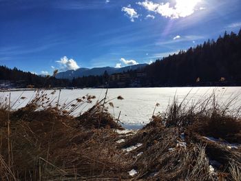 Scenic view of lake against sky during winter