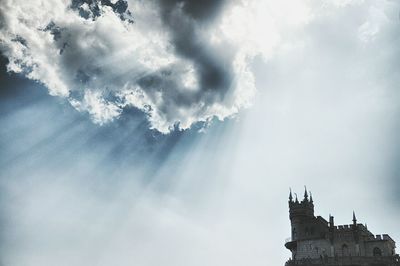 High section of building against cloudy sky