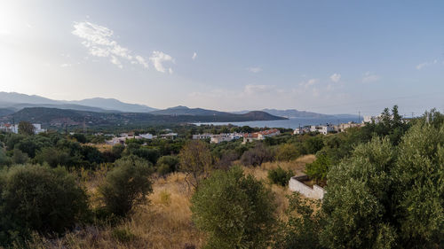 High angle view of townscape by sea against sky