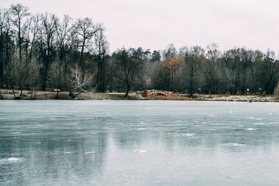 Frozen lake against sky during winter