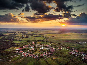 Scenic view of field against sky during sunset