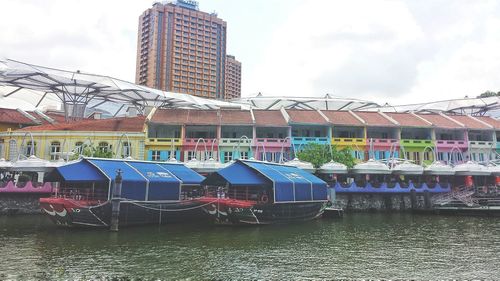 Boats in river with buildings in background