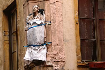 Low angle view of clothes hanging on wall of building