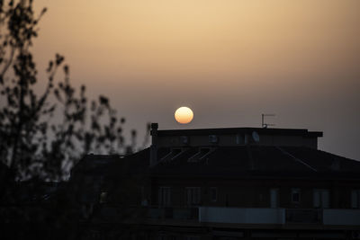 Silhouette building against sky during sunset