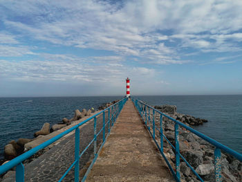 Pier over sea against sky