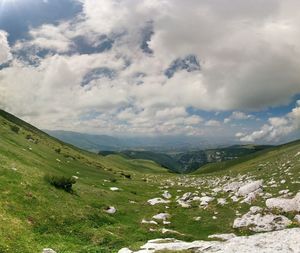 Scenic view of landscape against cloudy sky