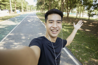 Portrait of smiling young man using mobile phone