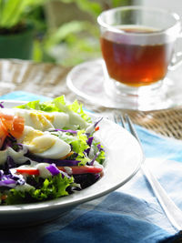 Close-up of salad with boiled eggs in plate on table