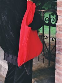 Rear view of woman holding red umbrella