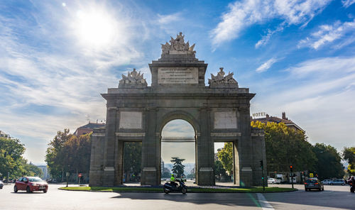 Low angle view of puerta de toledo against sky in city