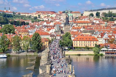 High angle view of people on charles bridge over river in city