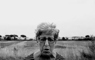 Portrait of man on field against sky