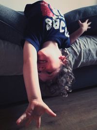 Portrait of boy lying on carpet at home