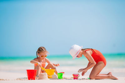 People on beach against sky