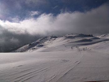 Scenic view of snow covered mountains against sky