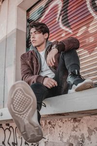 Portrait of young man sitting outdoors