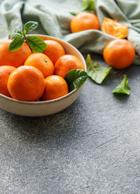 Fresh citrus fruits tangerines, oranges on a concrete background