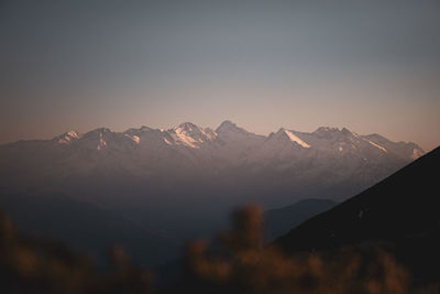 Scenic view of snowcapped mountains against sky during sunset